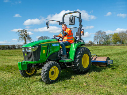 John Deere 3038E compact tractor and trailed roller