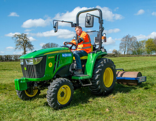 John Deere 3038E compact tractor and roller attachment