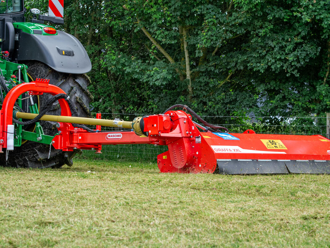 Maschio 2.6m flail giraffa topper rear mounted side arm on a john deere tractor cutting grass