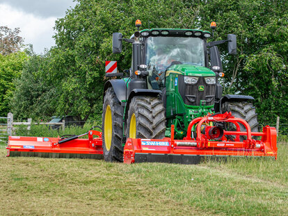 Maschio Buffalo and Giraffa XXL toppers mounted on a john deere tractor cutting grass