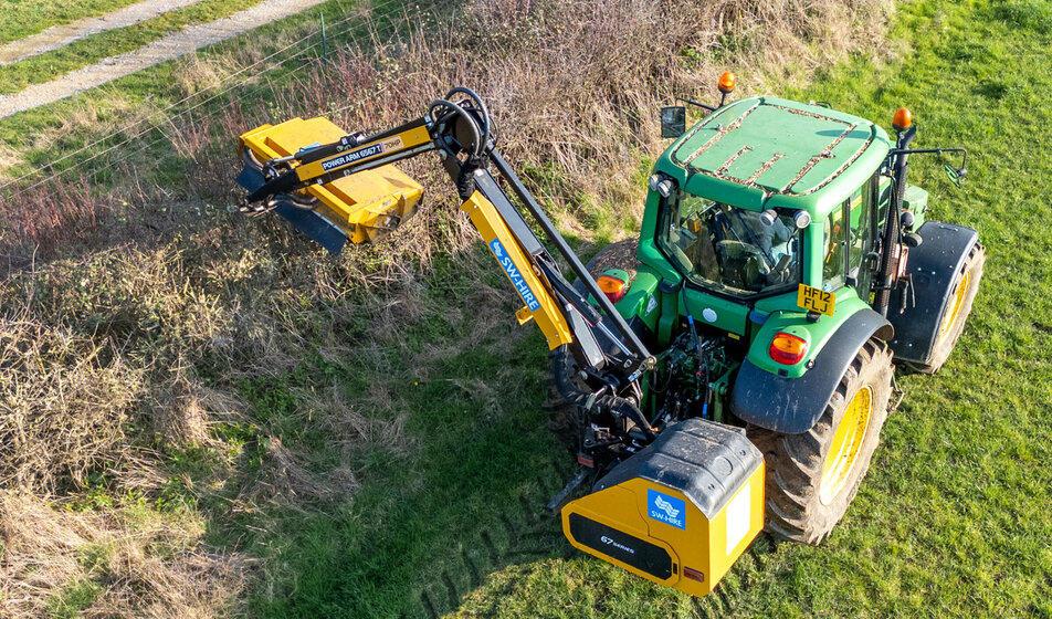 McConnel PA6567T hedgecutter trimming a hedge on a john deere tractor