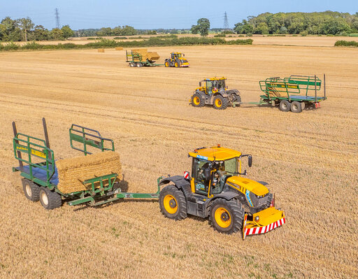 three JCB fastrac tractors with bale chasers in a stubble field