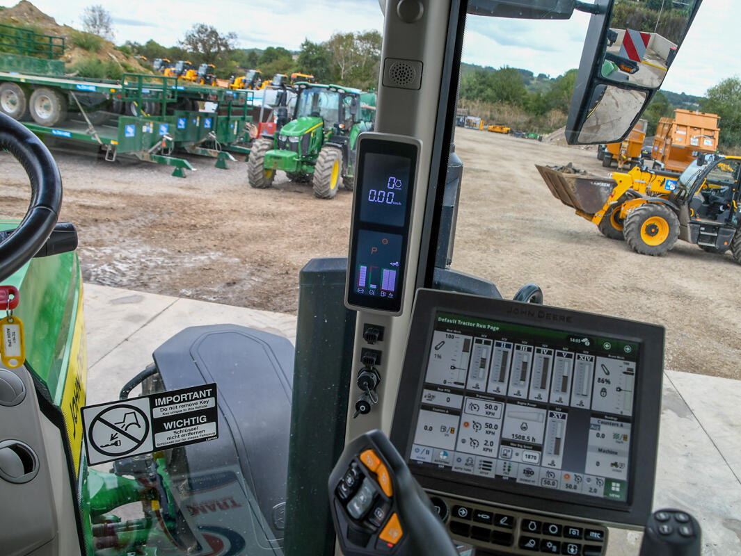 John Deere 8R370 tractor parked on a concrete pad