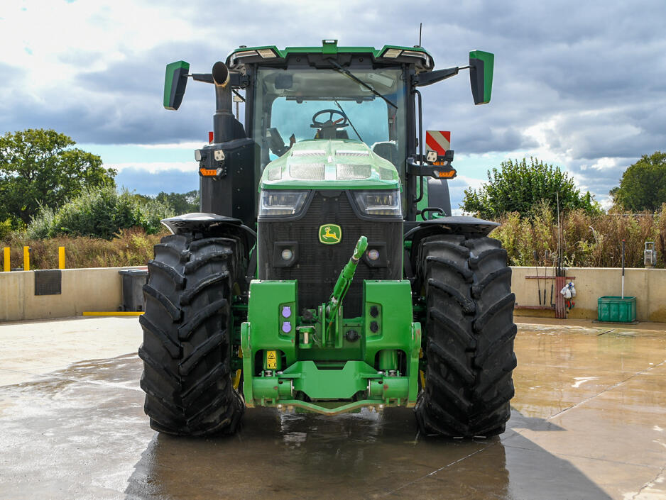 John Deere 8R370 tractor parked on a concrete pad