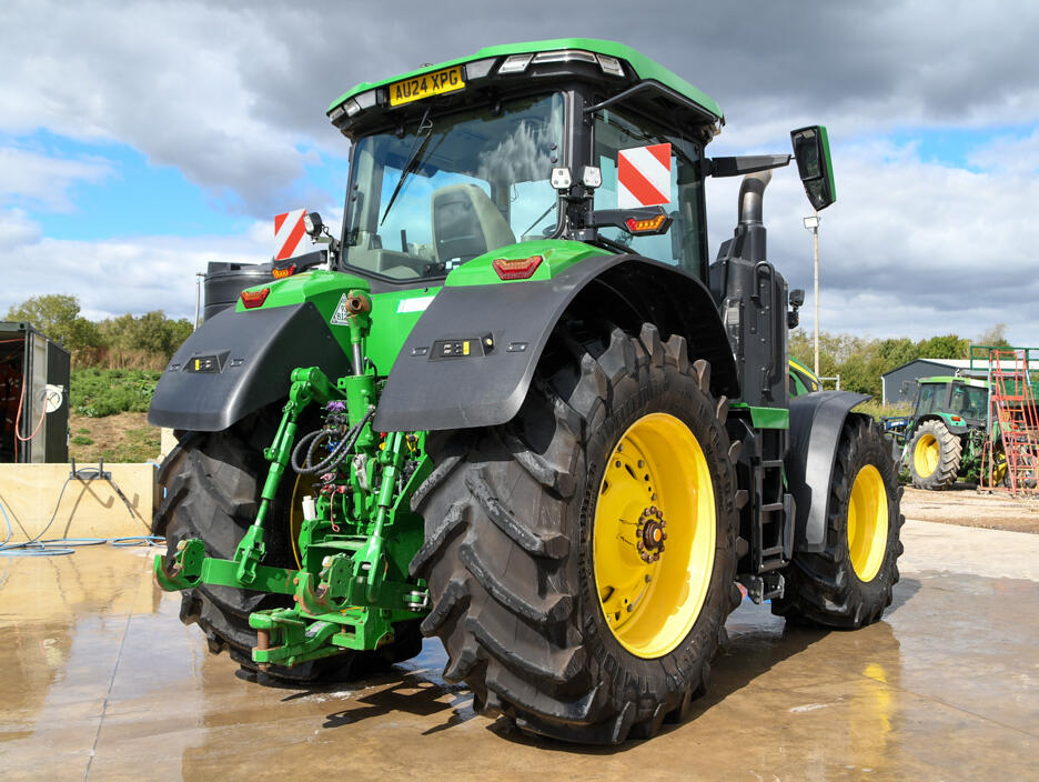 John Deere 8R370 tractor parked on a concrete pad