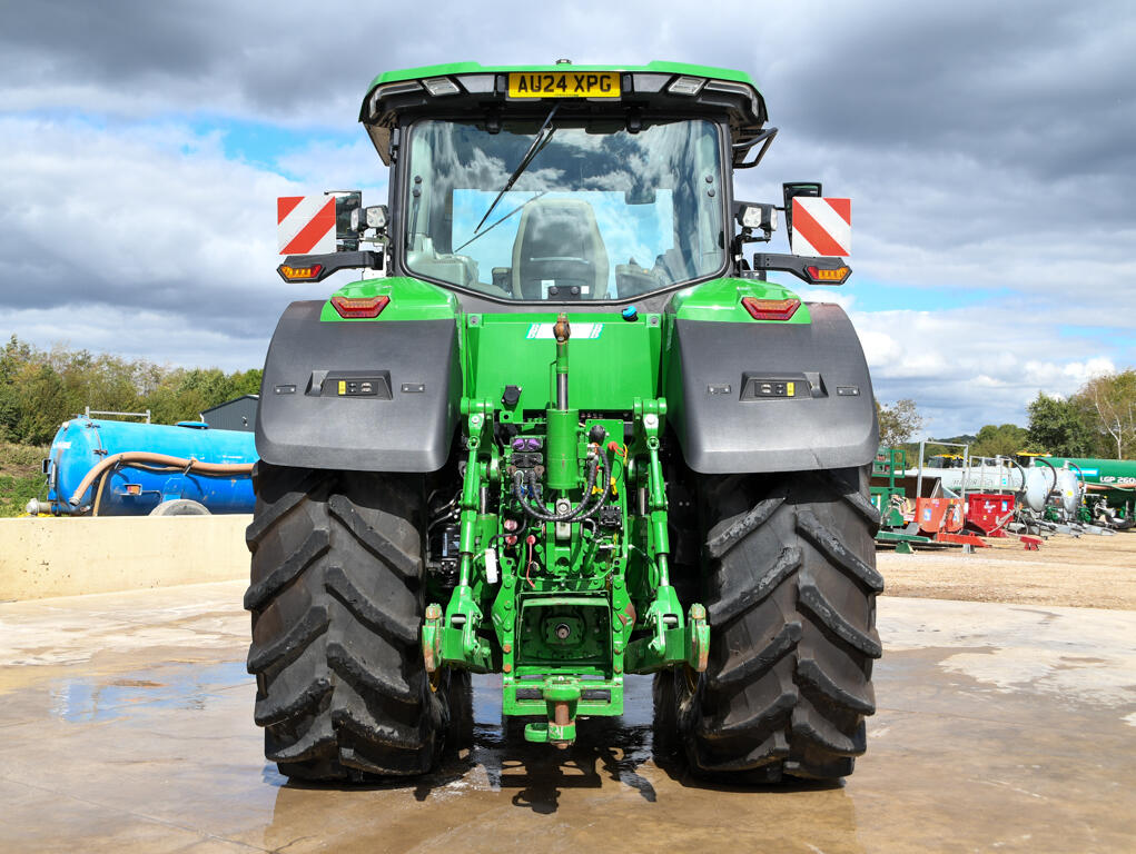 John Deere 8R370 tractor parked on a concrete pad