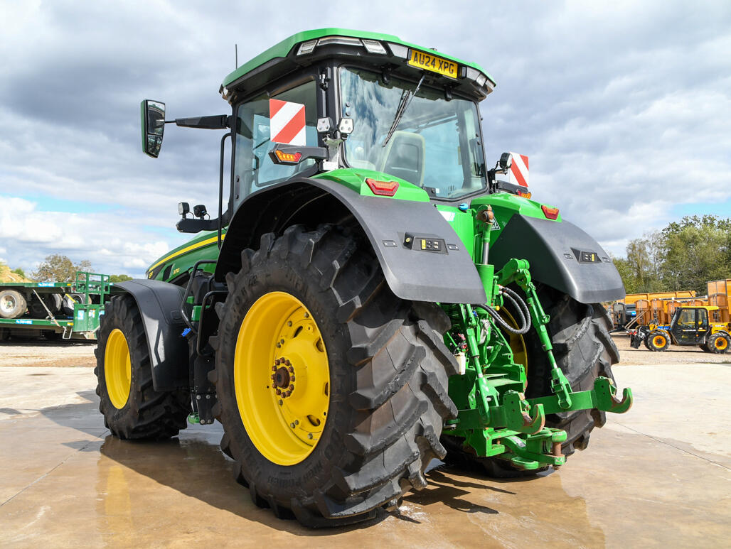 John Deere 8R370 tractor parked on a concrete pad